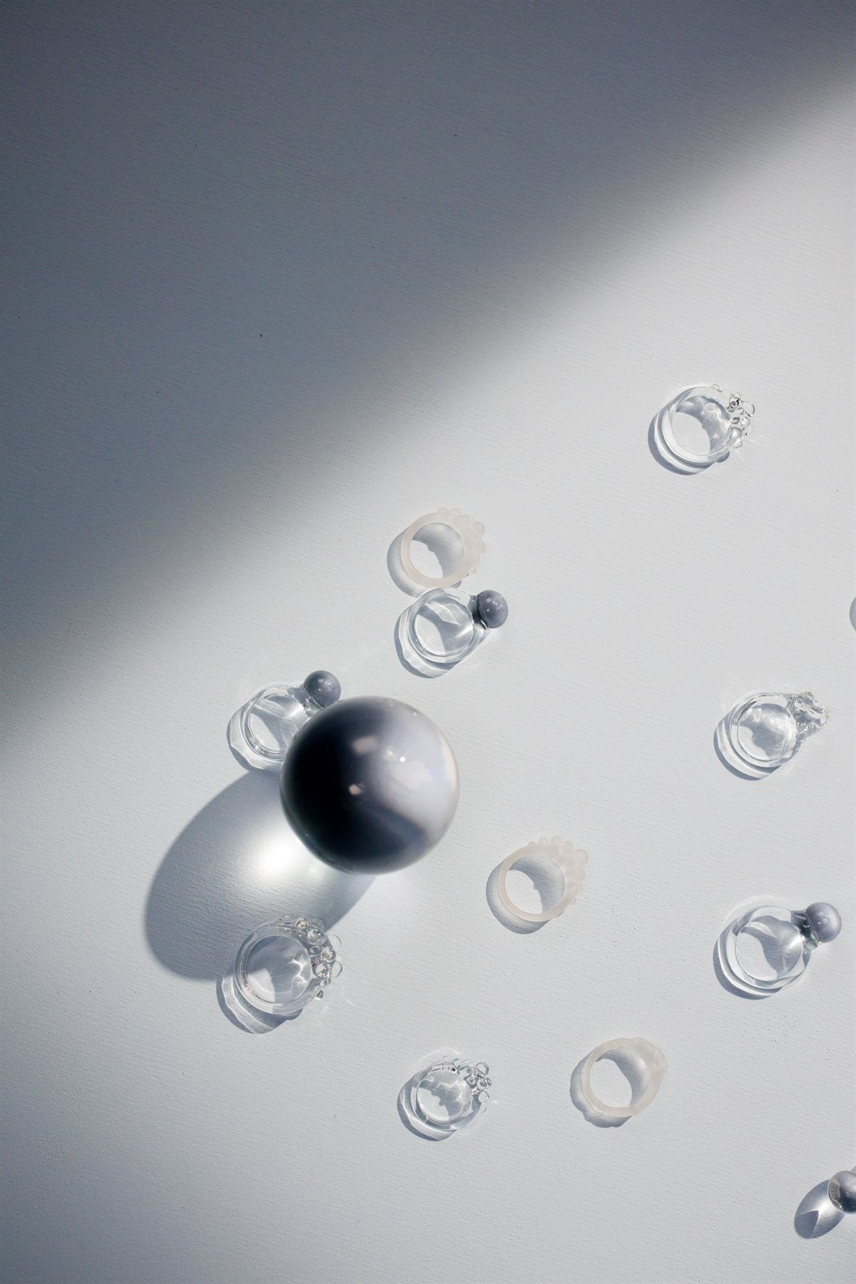 Frosted quartz stacking rings on a soft white surface